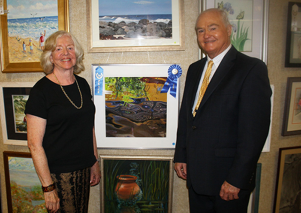 Freeholder John P. Curley congratulates Marilyn Baldi of Tinton Falls for winning Best in Show in the professional category for her photograph “Phantom” at the 2015 Monmouth County Senior Art Contest & Exhibition on August 19, 2015 at the County Library Headquarters in Manalapan, NJ.
